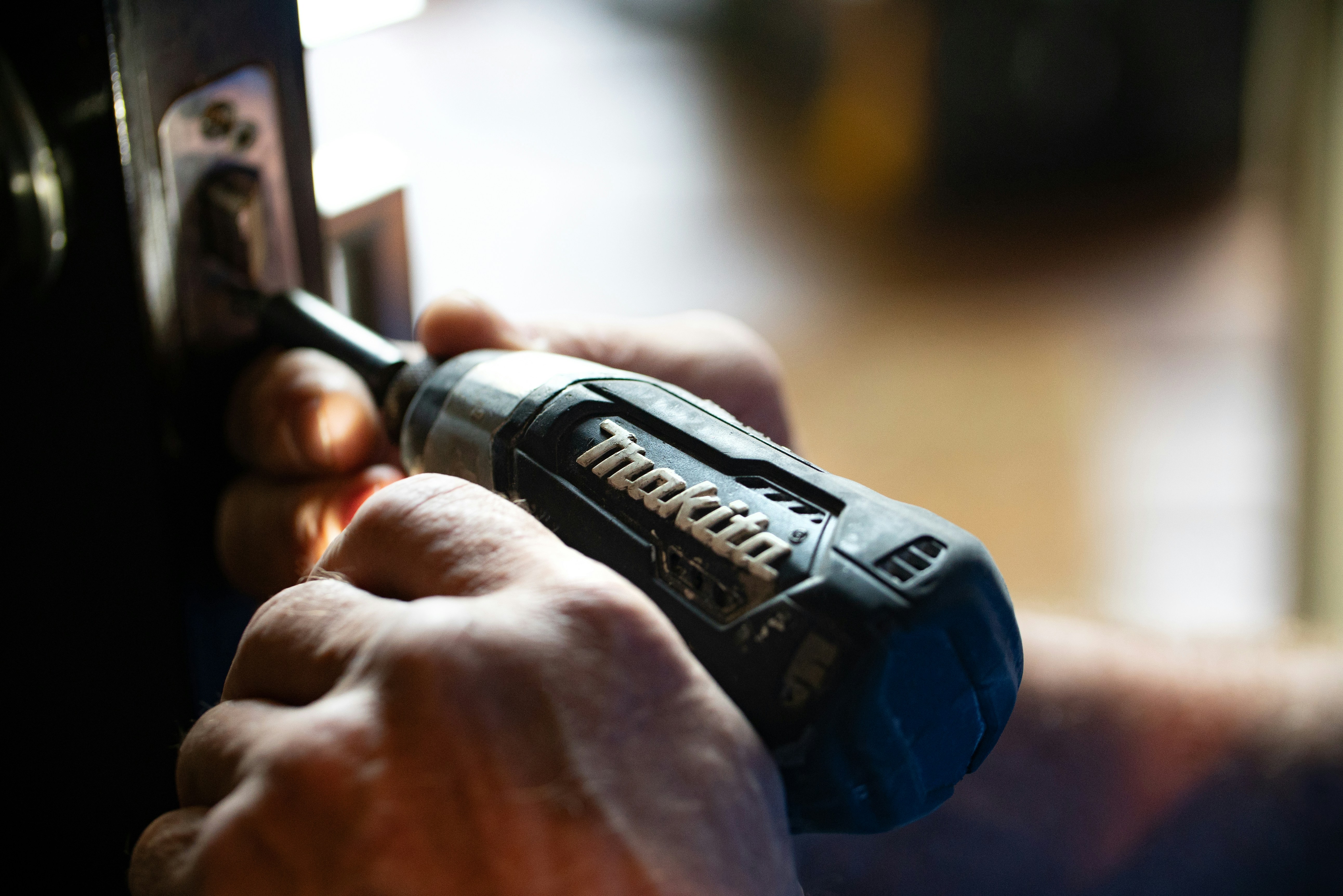 Facility maintenance technician fixing your door lock