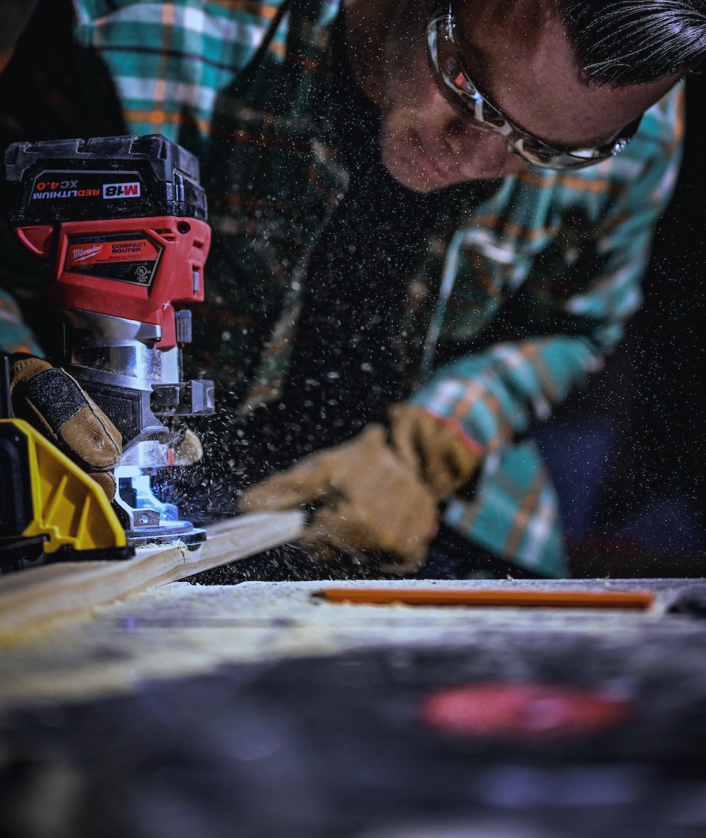 Technician cutting wood, handyman sawing wood